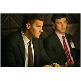 Bones David Boreanaz as Agent Booth Wearing Dark Suit Sitting Looking to Side with John Francis Daley as Dr. Sweets in Background Closeup 8 x 10 Photo
