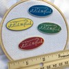 Stitch and Flick (Green/Silver) Hard Enamel Needle Minder