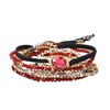 AeraVida Stylish Oval Shaped Faceted Crystal with Red and Metallic