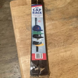 THE CAP RACK BY HOLDS UP TO 10 CAPS, ATTACHES TO WALL