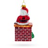Cozy Santa Sitting on Fireplace Glass Christmas Ornament