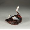 Brown Pelican Trio by John Perry Sculpture on burlwood base