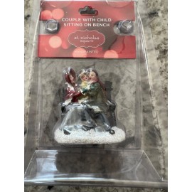 St. Nicholas Square Couple with child sitting on bench st nicholas square