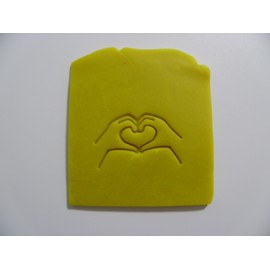 Hands into a heart stamp for many uses soap making and pottery