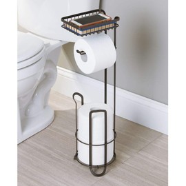 mDesign Toilet Roll Holder - Free Standing - No Drilling Necessary - Loo Roll Holder for The Bathroom - Toilet Paper Holder Stand - Added Space for Brush - Bronze
