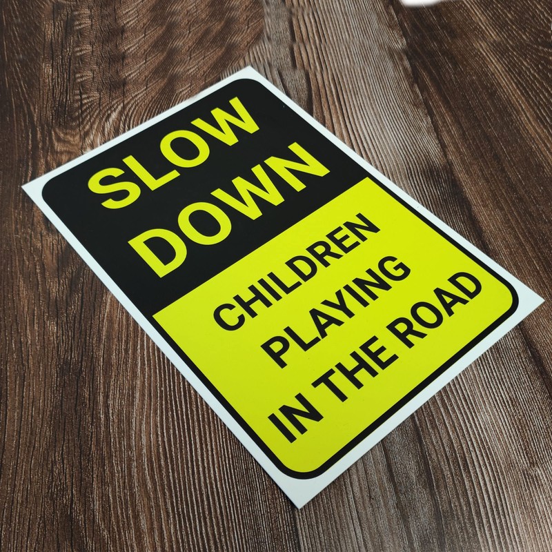 'SLOW DOWN, CHILDREN PLAYING IN THE ROAD' WARNING SIGN. TOUGH,