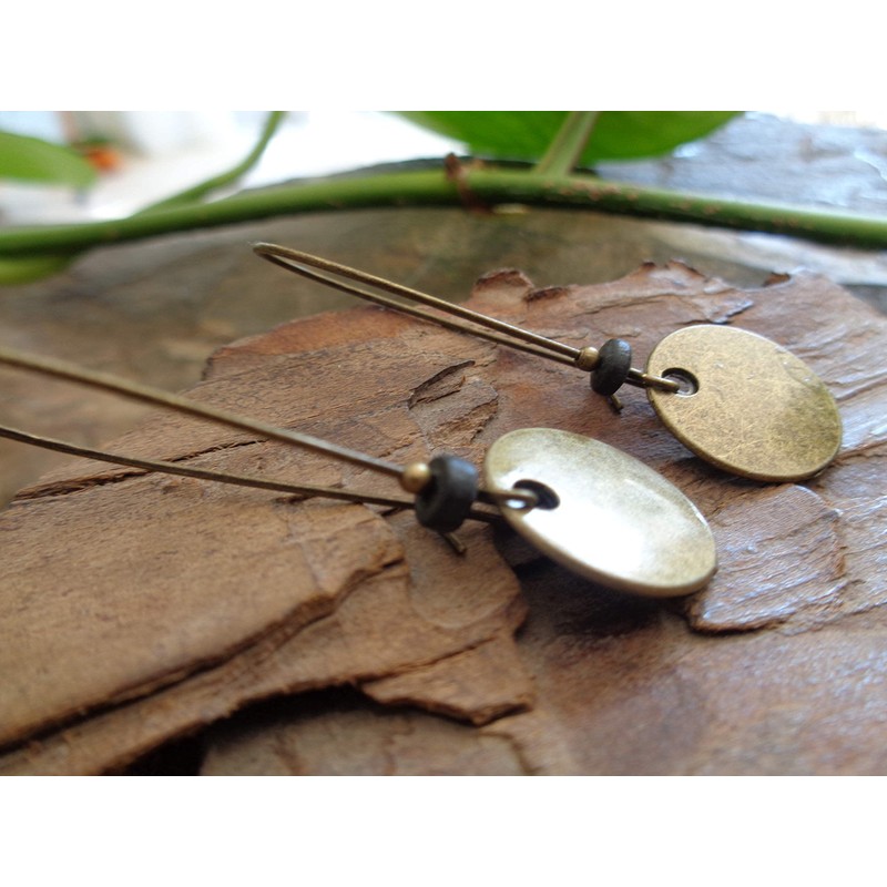 Thick bronze discs and ceramic earrings and kidney hooks