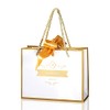 A neige Gift Bag with Gold Ribbon