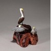 Brown Pelican Trio by John Perry Sculpture on burlwood base