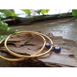 5.5 cm large gold stainless steel hoop earrings with removable evil eye enamel pendant. Smooth earrings with unique pendant