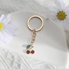 MUCOOS Small cherry key ring, decorated with delicate small rhinestones,