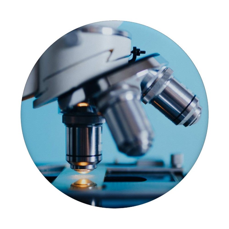 Compound Microscope and Slide Against Light Blue Background