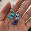 Meimimix Llavero de mariposa esmaltada con borla para mujeres y