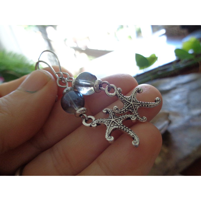 Starfish and blue soap bubbles glass. Beautiful earrings on unique