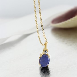 Gem Stone King 18K Yellow Gold Plated Silver Blue Lapis and White Diamond Pendant Necklace For Women (2.07 Cttw, Gemstone Birthstone, Oval 9X7MM, with 18 Inch Silver Chain)