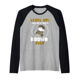 This kid is now a brown belt Raglan Baseball Tee
