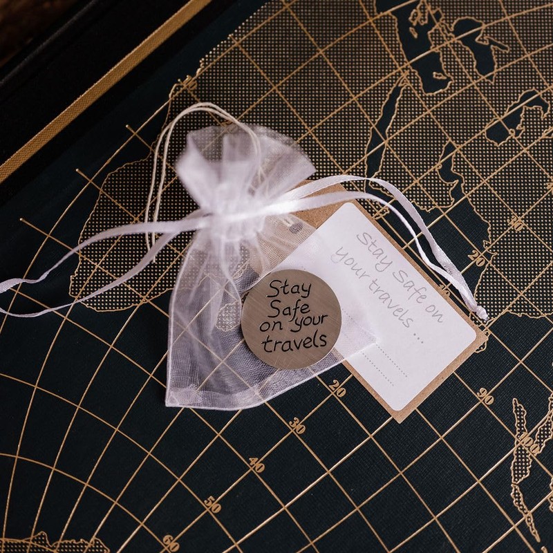 Compass travel token with 'Stay safe on your travels' message