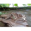 Delicate star hoop earrings made of stainless steel. Star-shaped large