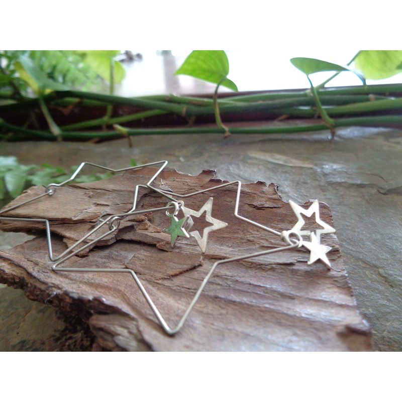 Delicate star hoop earrings made of stainless steel. Star-shaped large
