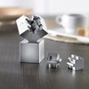 The magnetic metal puzzle pieces become a 3D puzzle that