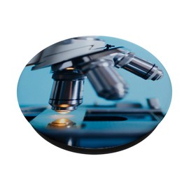 Compound Microscope and Slide Against Light Blue Background