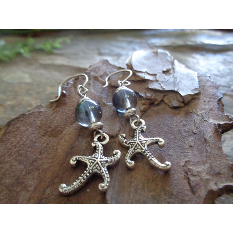 Starfish and blue soap bubbles glass. Beautiful earrings on unique