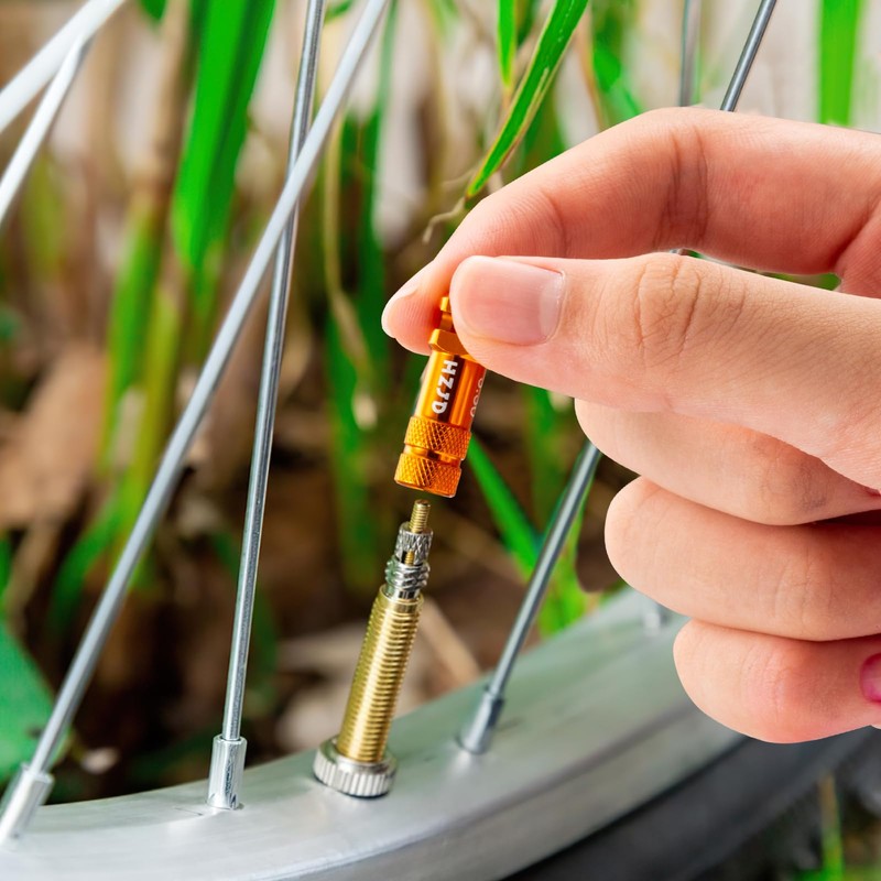 Bicycle Presta Valve Caps Orange with Integrated Spoke Removal Function