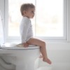 Ubbi Adjustable Toilet Trainer with Built-In Handles and Included Potty