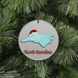 North Carolina Christmas Ornament - Winter Theme Featuring Snow, State Terrain Map and Santa Cap - 2024 Acrylic Tree Decoration - Holiday Gift and Home Decor