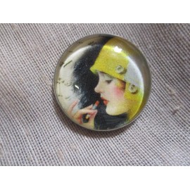GLASS DOME PIC BUTTON LADY IN YELLOW BUCKET RAIN HAT APPLYING LIPSTICK    1 INCH