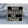 Finally Home Iron-On Patch "Kein Mensch ist illegal" [German Language]