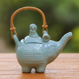 NOVICA Light Blue Ceramic Teapot with Rattan Handle, 27 Oz, Buddha and The Turquoise Elephant'