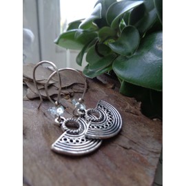 Aquamarine on long hooks and decorated ethnic semicircle, unique beautiful earrings with light blue stone splinters