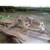 Delicate star hoop earrings made of stainless steel. Star-shaped large