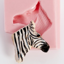 Zebra Head Silicone Mold Chocolate, Fondant, Candy, Mints, Resin, Clay. Mold creates a small flat backed zebra head perfect size for candy, cupcake toppers, jewelry and more.
