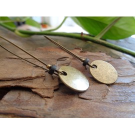 Thick bronze discs and ceramic earrings and kidney hooks