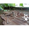 Delicate star hoop earrings made of stainless steel. Star-shaped large
