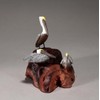 Brown Pelican Trio by John Perry Sculpture on burlwood base
