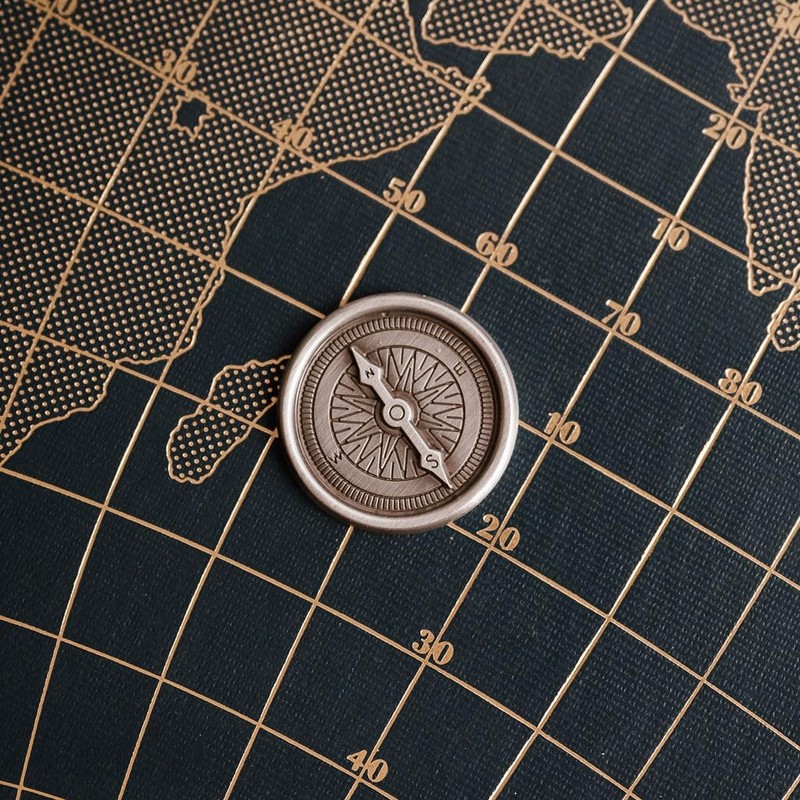 Compass travel token with 'Stay safe on your travels' message