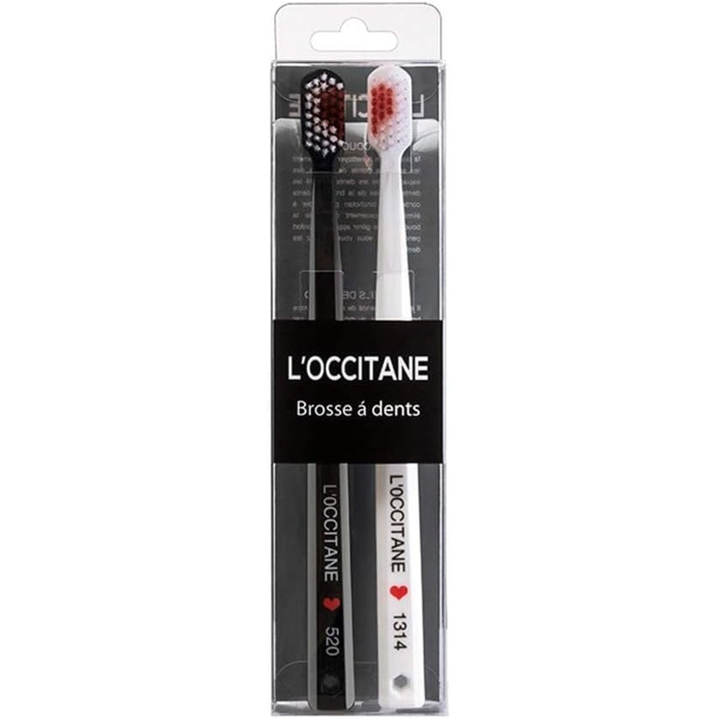 2 cepillos de dientes blancos y negros en forma de