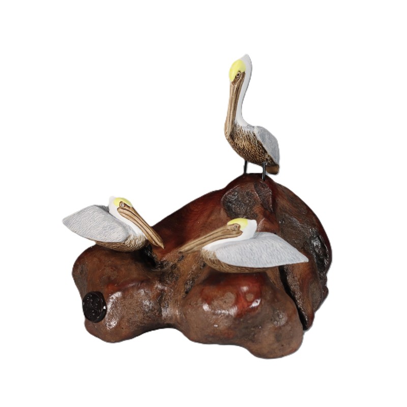 Brown Pelican Trio by John Perry Sculpture on Polished burlwood