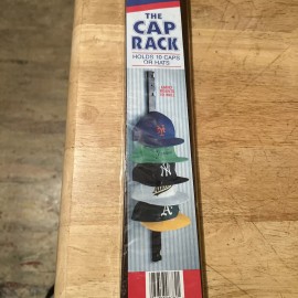THE CAP RACK BY HOLDS UP TO 10 CAPS, ATTACHES TO WALL