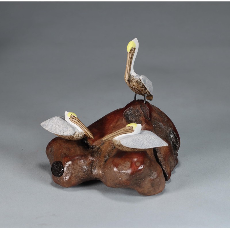 Brown Pelican Trio by John Perry Sculpture on Polished burlwood