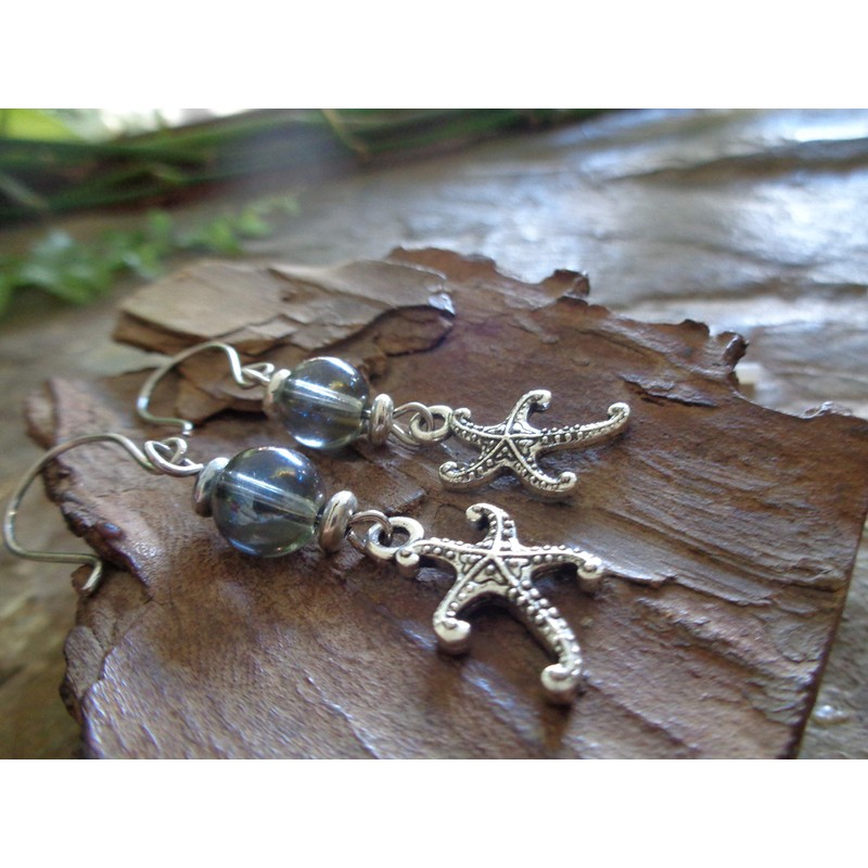 Starfish and blue soap bubbles glass. Beautiful earrings on unique