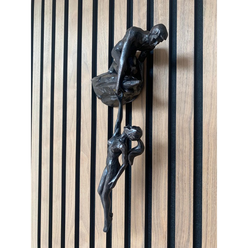 Haute Collage Man on cliff edge holding a hanging woman