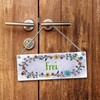 Grey toilet is free or occupied reversible sign with flower