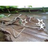 Delicate star hoop earrings made of stainless steel. Star-shaped large