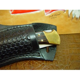 Buck Custom Left Hand Cross Draw Knife Sheath for a 110 Knife. The Sheath is Made Out of Buffalo Hide Leather Hand Tooled with a Basket Weave Pattern.