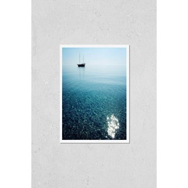 Poster Reproduction of Morning sea with boat on the horizon. Aged photo. Sailing ship profile. Toned image. Sunbeams on the sea surface. Calm Sea with a Sailing Vessel. Cirali, Antalya Province