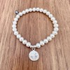 Agálea | Pulsera de Perlas naturales con dije de San